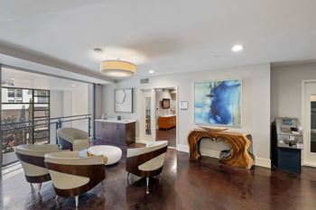 a living room filled with furniture and a large painting